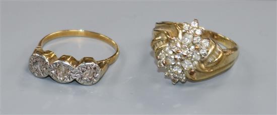 Two yellow metal and diamond set dress rings including illusion set three stone ring.